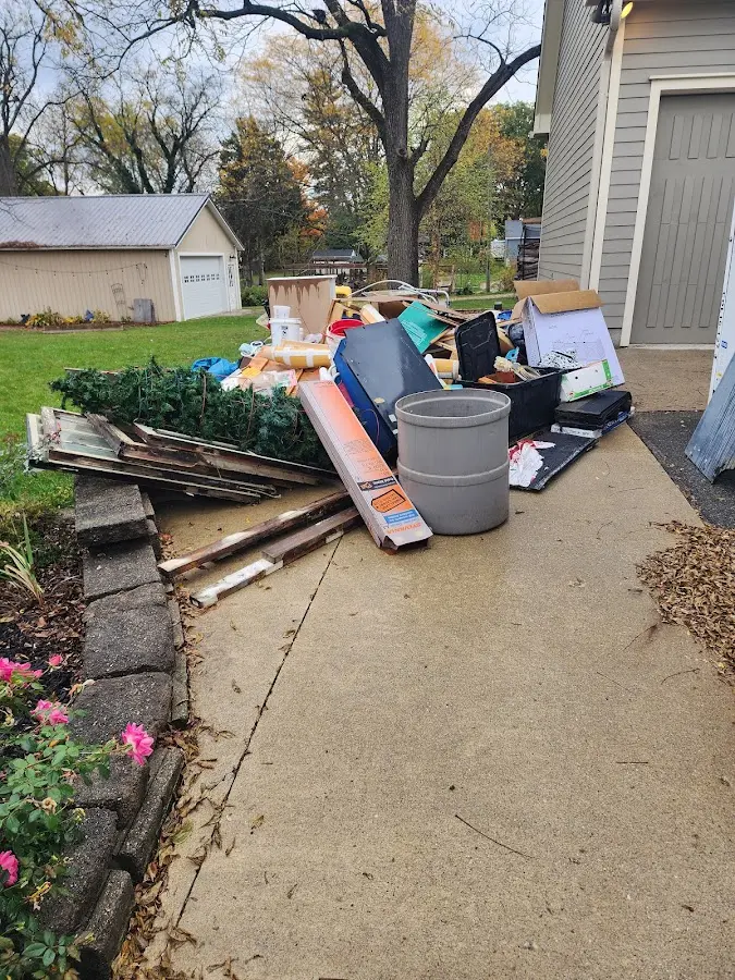 Dumpster being loaded with debris for Estate Cleanout Dumpster Rental in Thomson